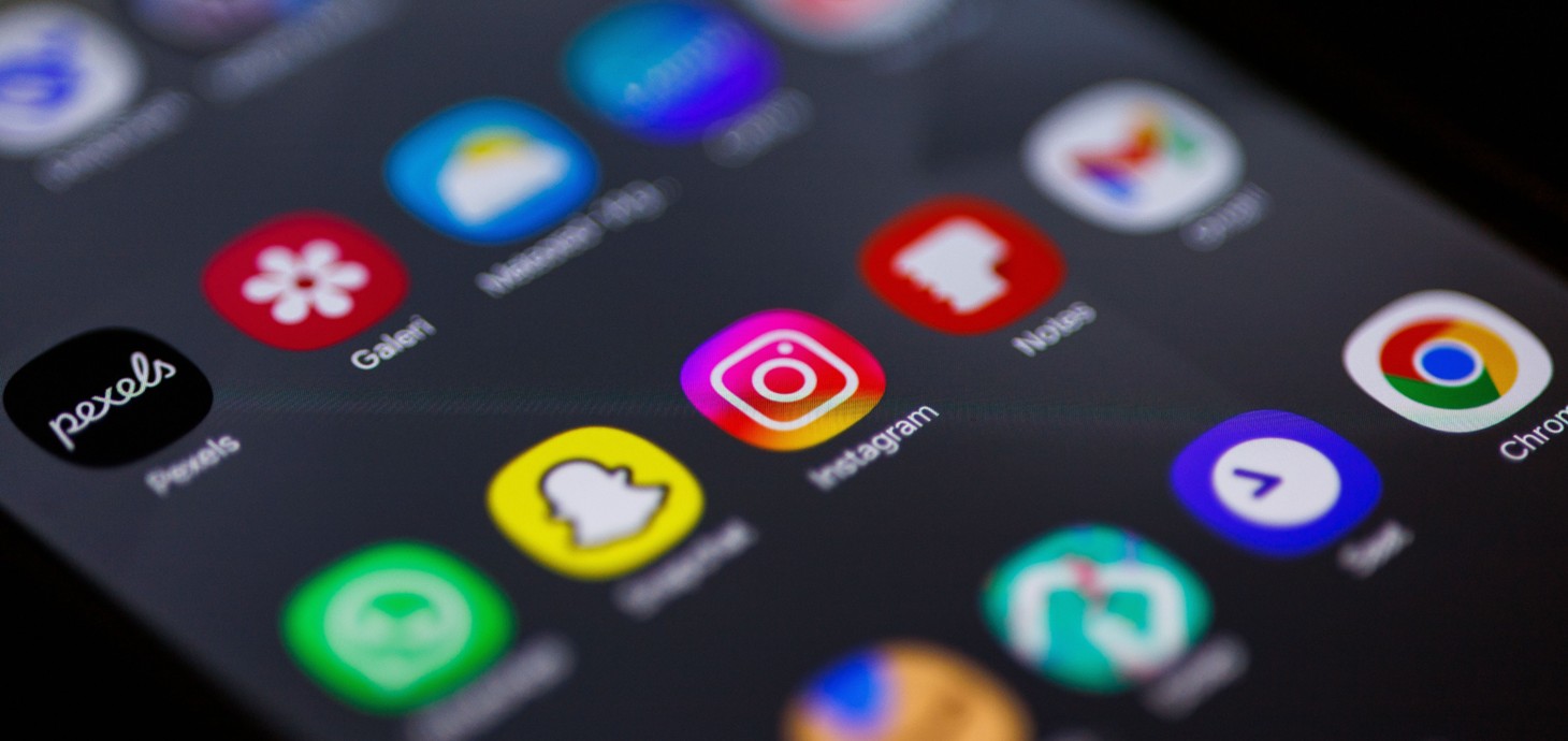 Close-up image of mobile phone screen featuring social media apps