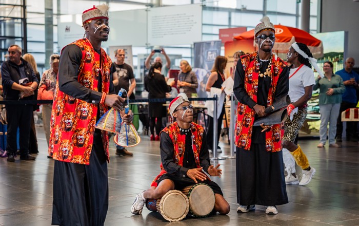 Group of African musicians performing inside a building.