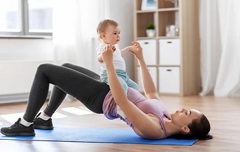 woman doing yoga with a baby