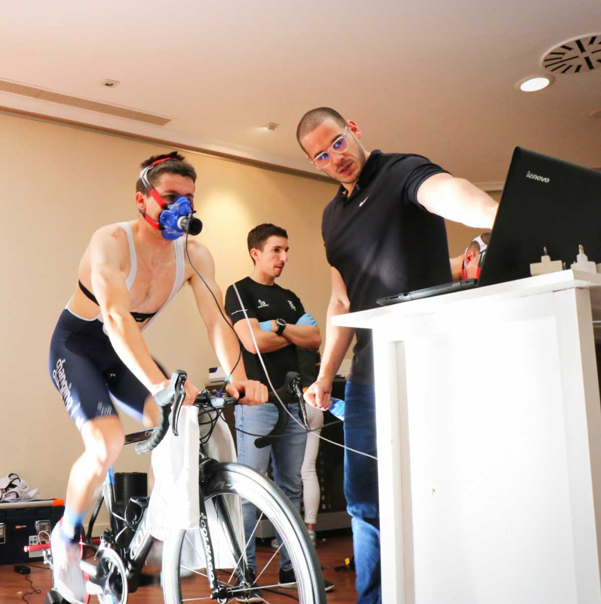researchers and subject on exercise bike