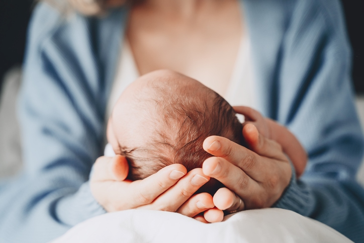 Newborn baby in mothers hands