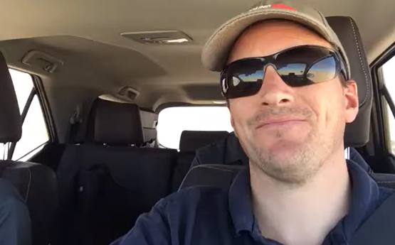 Professor Ben Evans in a vehicle driving to the track