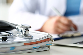 image of documents and stethoscope on a desk