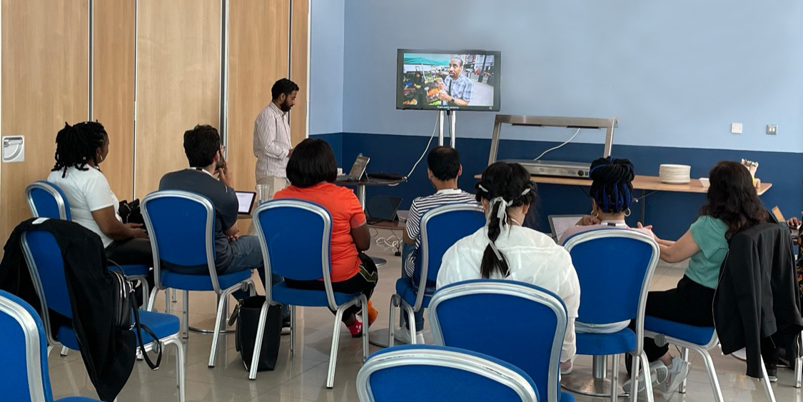 children in a class room watching an informative video 