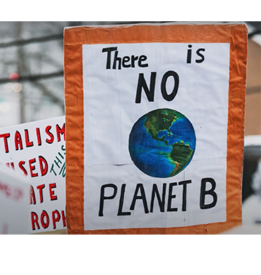 posters at a protest reading 'There is no Planet B'