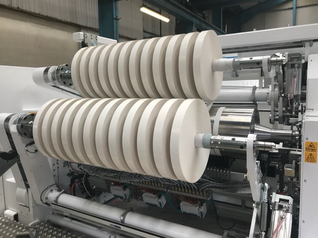 Reels of silicon release liner are wound on a machine