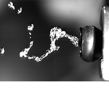 High-speed camera image capturing the analysis of the performance of a microfluidic nozzle developed by Kautex Textron CVS Ltd. 