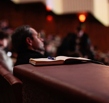 A conference hall, dimly lit