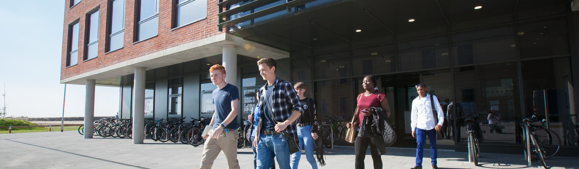 group of students walking out of a building
