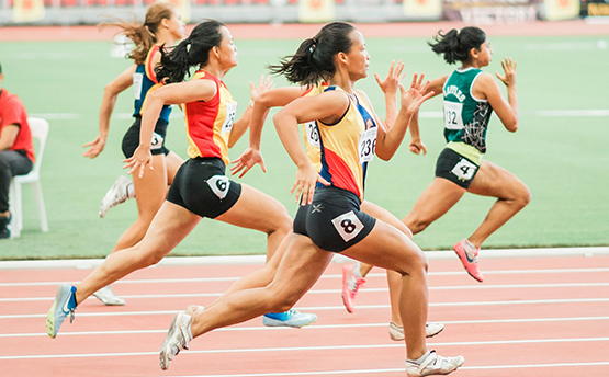 Female athletes running on a track