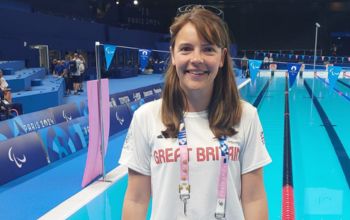 Verity Cook in her Team GB kit next to the arena pool 