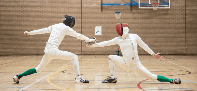 Two students taking part in fencing at the Swansea Bay Sports Park Hall