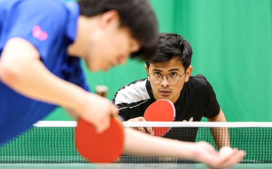 Two Swansea University students playing a table tennis match at Swansea Bay Sports Park