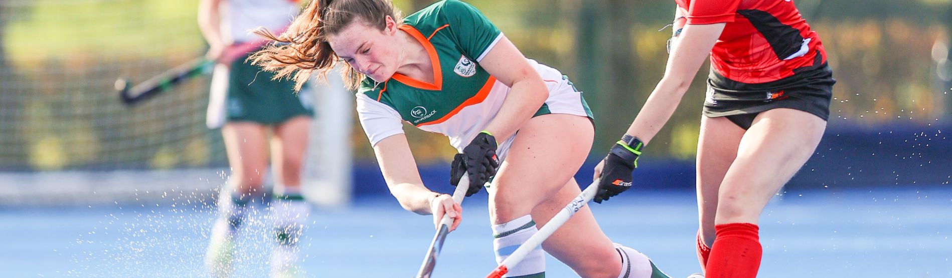 Swansea University womens hockey player takes on opponent player during hockey match