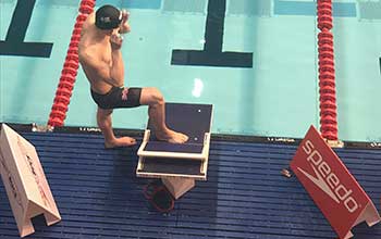 An image of Swansea University student and Sport Swansea swimming scholar Lewis Fraser getting ready to compete