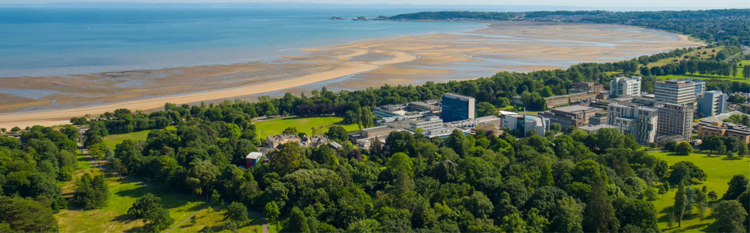 Ariel view of Singleton campus with the sea in the background 