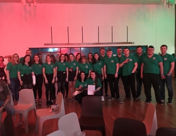 Welsh society students taking a photo in their green t-shirts for the Eisteddfod in 2019