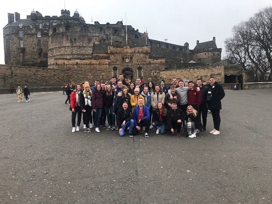 Students taking a photo in front of Edinburgh Castle