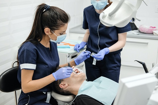 Dentist and nurse with patient