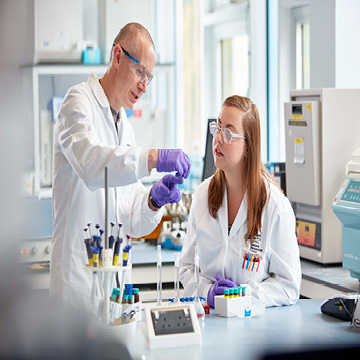 A student and lecturer in a lab