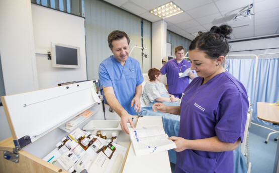 Nursing student and academic looking at medication