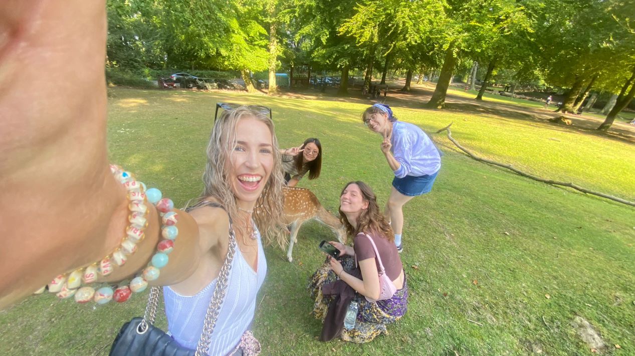 Student and friends in green field 