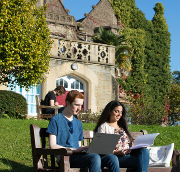 students sitting in front of Singleton abbey