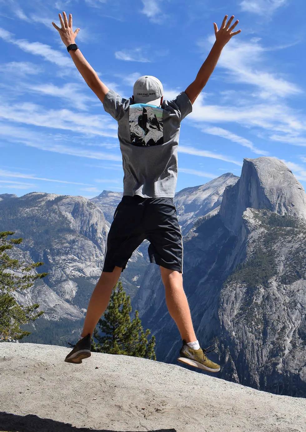 Person jumping with mountainous backdrop