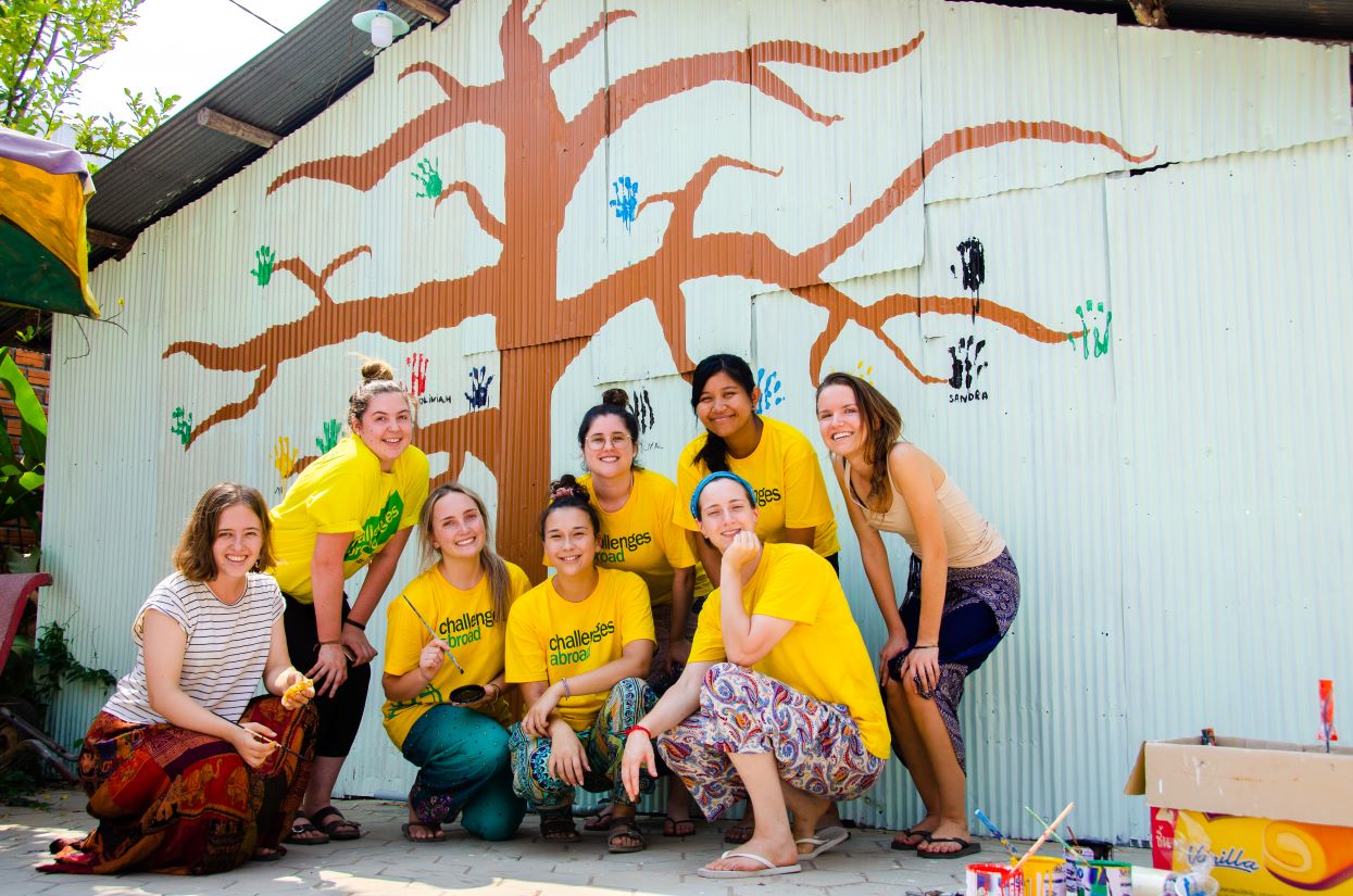 Group photo in front of painted wall