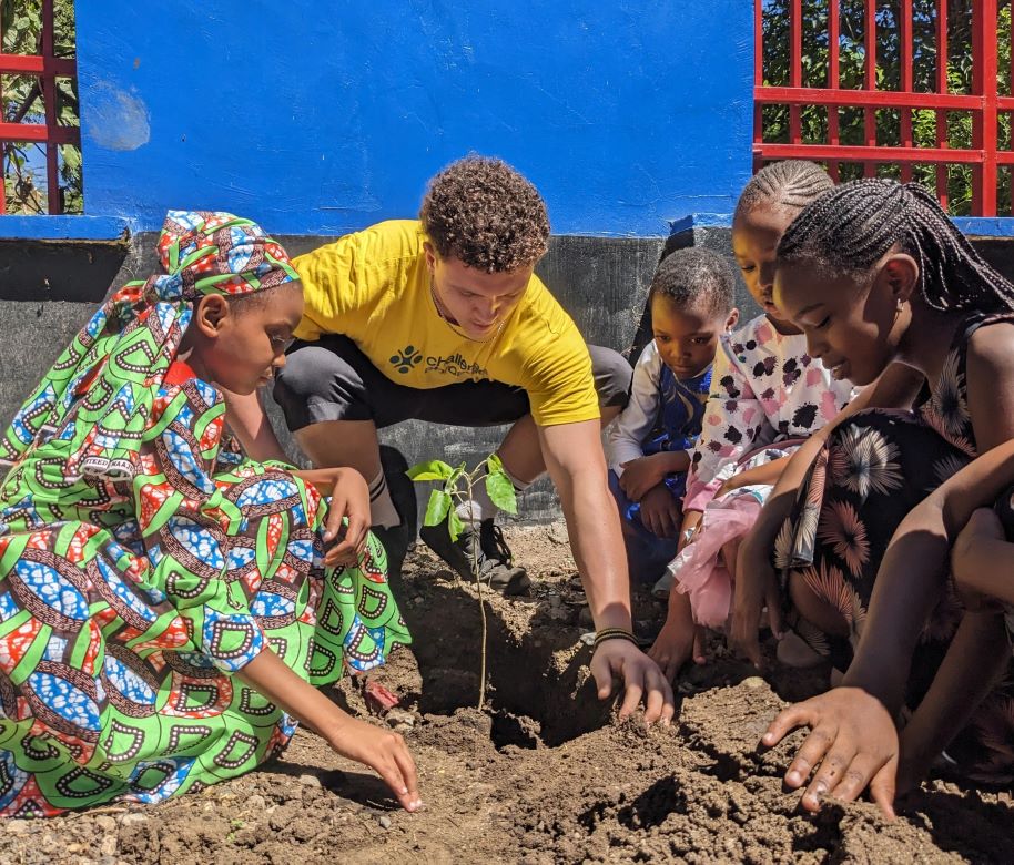 student helping to dig