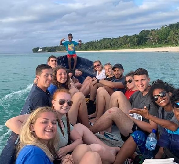 students in a boat on the sea