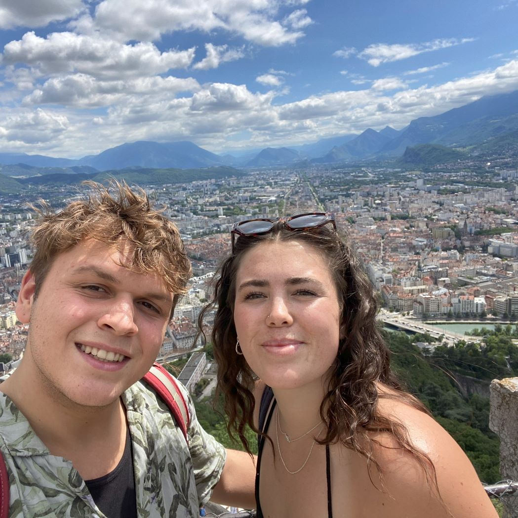 Student and friend in front of Lyon cityscape