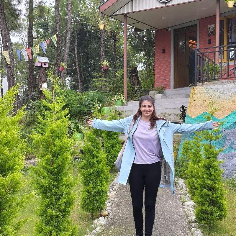 Student standing in from of coffee shop.