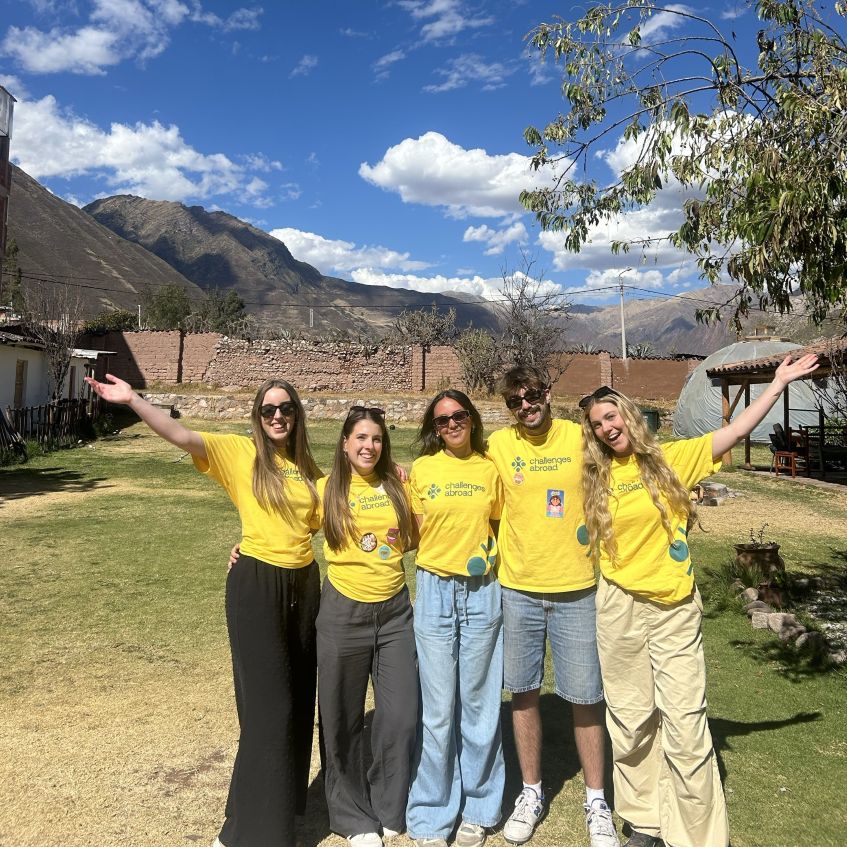 Group of students standing in front of Peruvian landscape