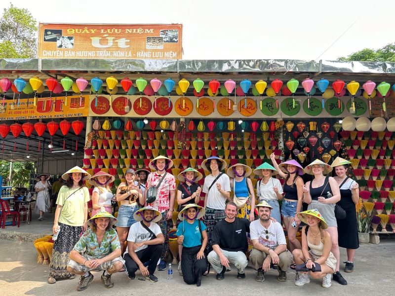 Group of students wearing hats in front of a colourful shop