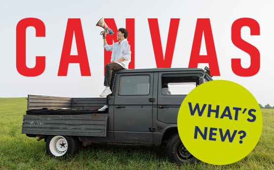 A man sat on the back of a van shouting through a megaphone