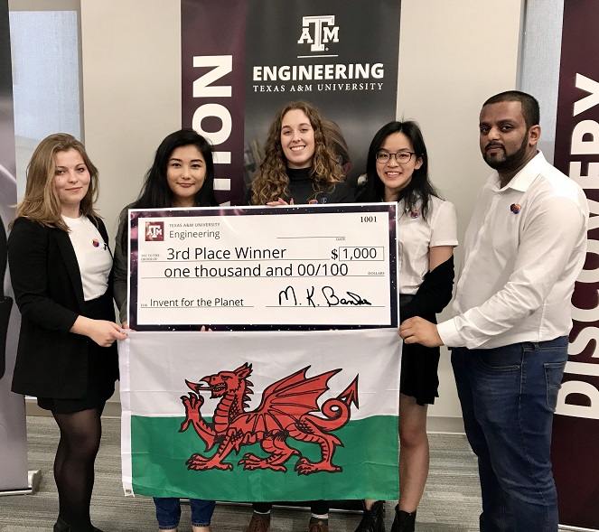 Students holding Welsh flag and 3rd place cheque for $1000