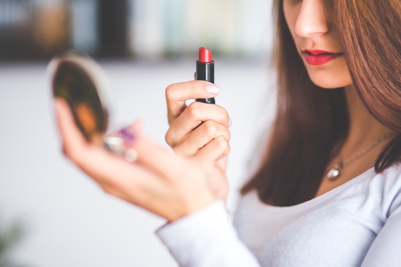 Woman about to apply red lipstick