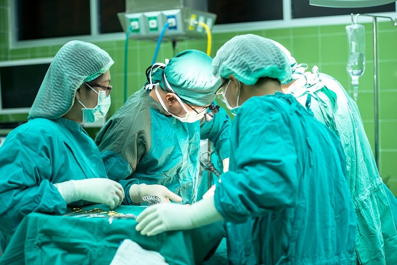 Surgeons in scrubs carrying out surgery
