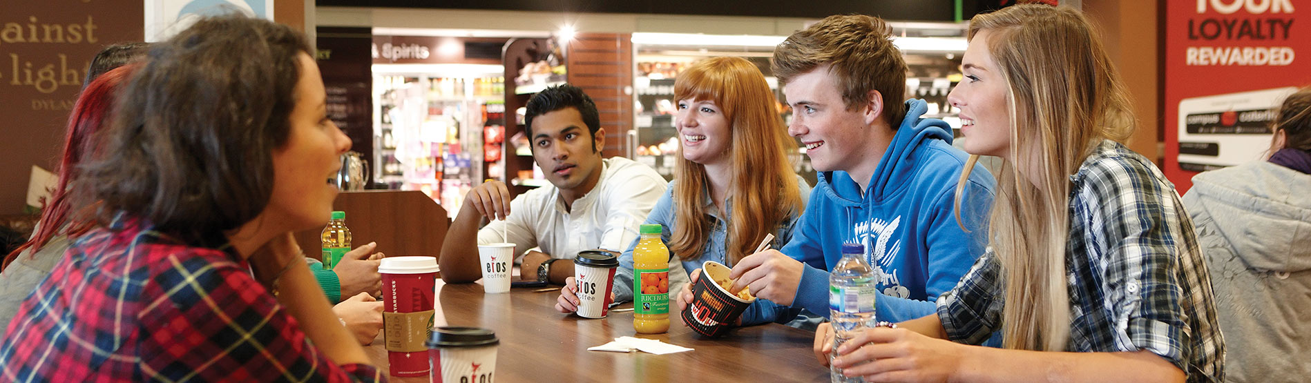 Students socialising during lunch in an on-campus cafe.
