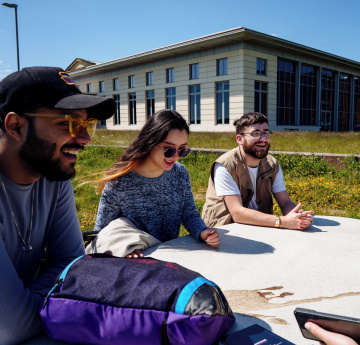 Students sitting together outdoors on Bay Campus