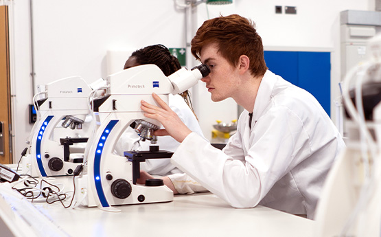 A student using a microscope