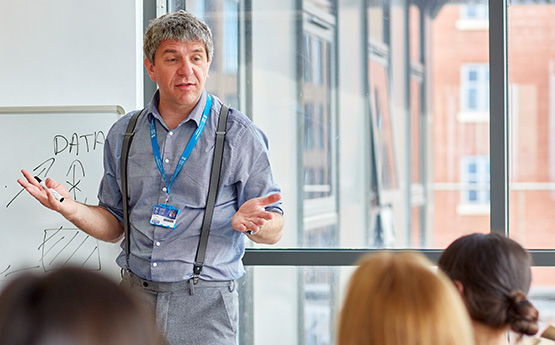 A teacher addressing students