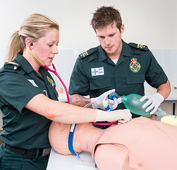 Paramedic Students practicing on a model