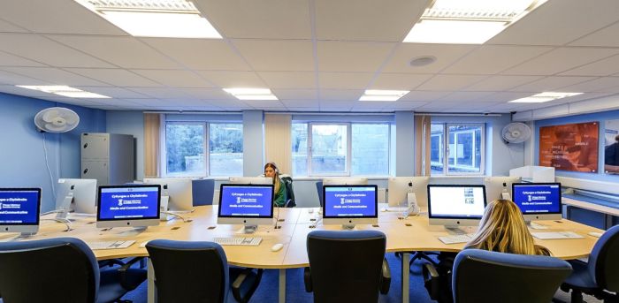 Students working at Apple computers in a digital media lab