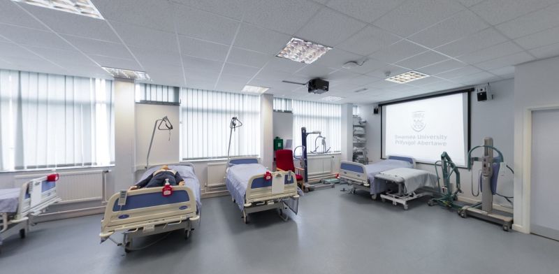 Clinical skills suite with hospital beds and patient care equipment