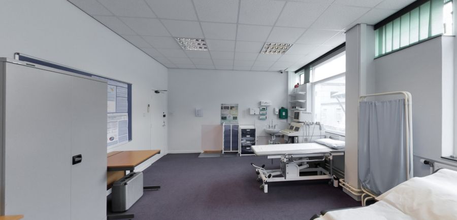 Clinical teaching room with examination beds and medical equipment