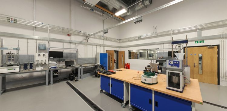 Geomechanics lab with testing rigs, workbench, and instruments