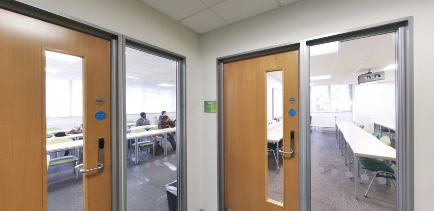 University classrooms with desks, chairs and students in lessons