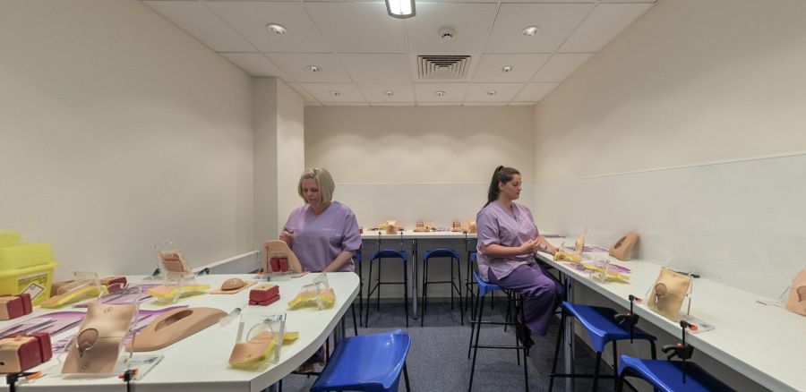 Clinical practice suite with anatomy models and hands-on training stations